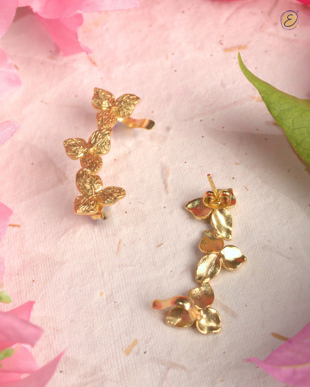 Gold-plated bougainvillea floral ear climber with three delicate flowers and U-clip, styled for festive wear.
