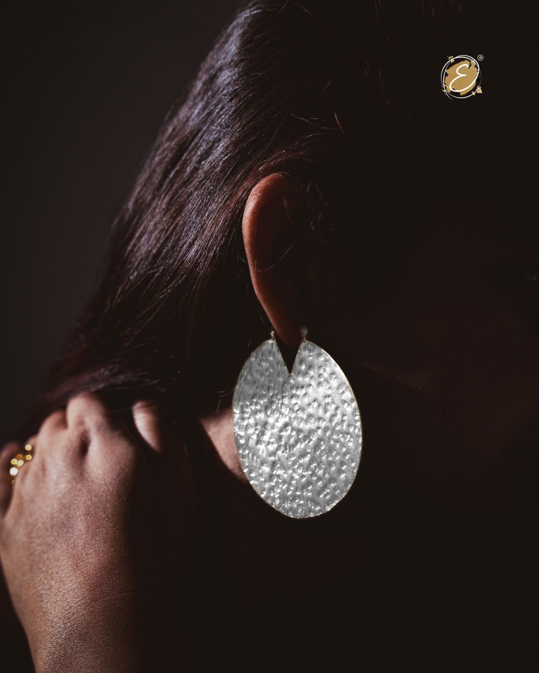 Silver hoop earrings inspired by the eclipse silhouette, featuring a curved modern form, handcrafted and silver-plated
