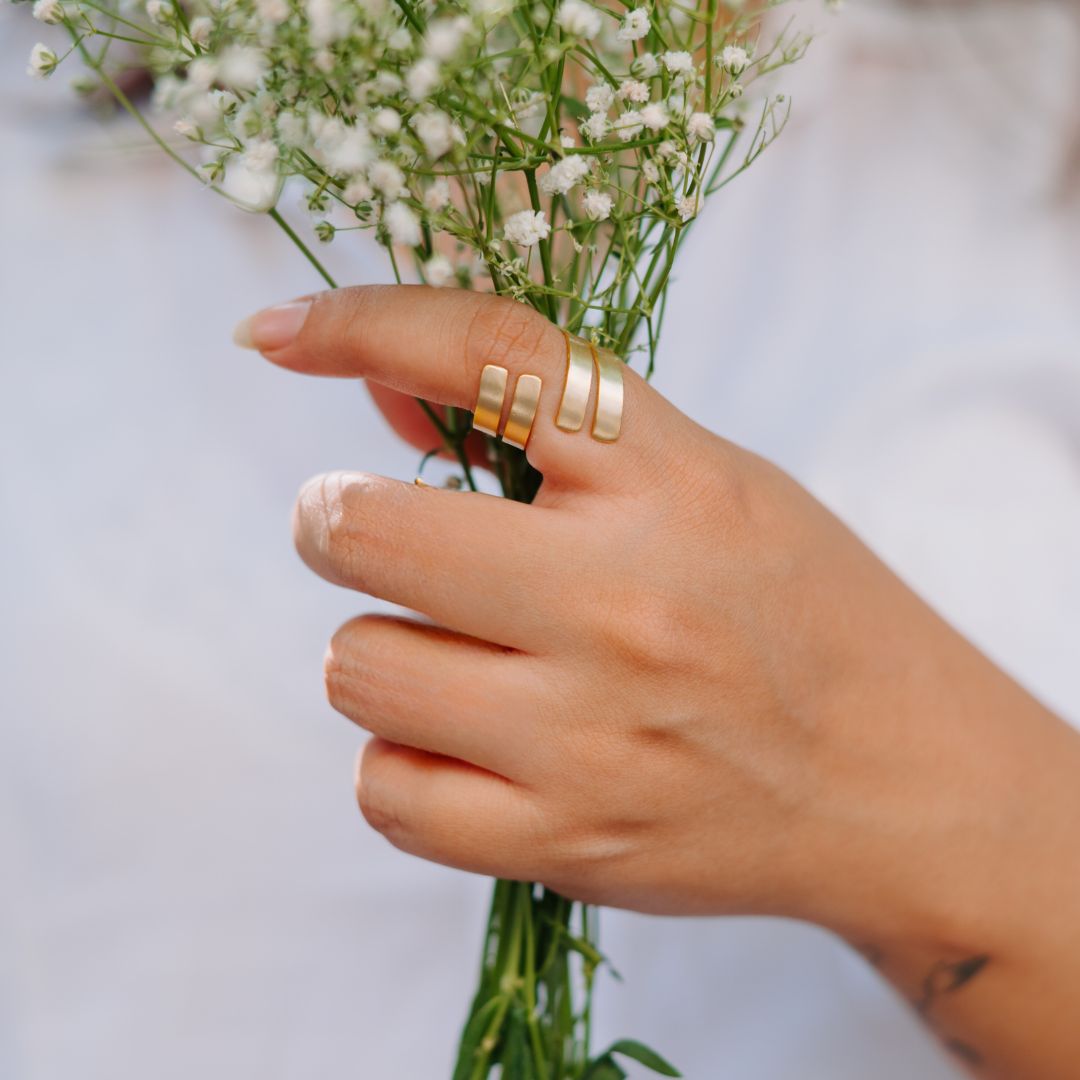 Gold Trudy ring worn on hand, showcasing its elegance